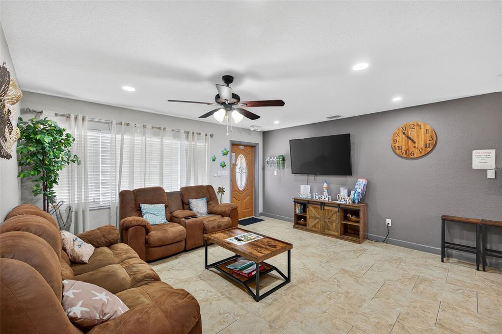 1576 Rosery Road Northeast Largo, FL 33756 - Photo 15 of 54 a living room with furniture and a flat screen tv