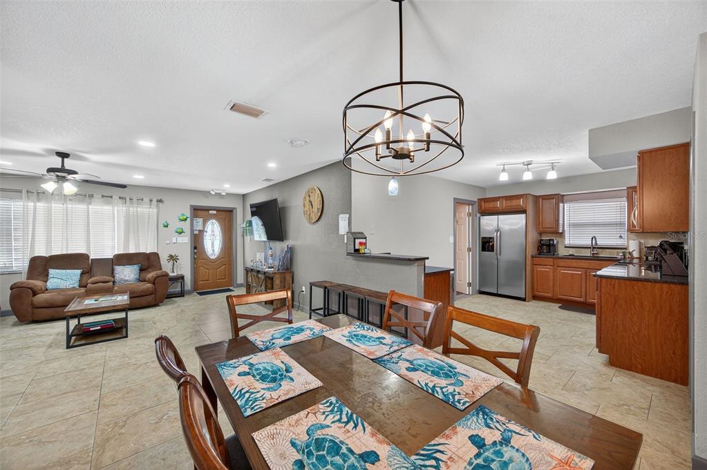 1576 Rosery Road Northeast Largo, FL 33756 - Photo 20 of 54 a living room with furniture kitchen view and a chandelier