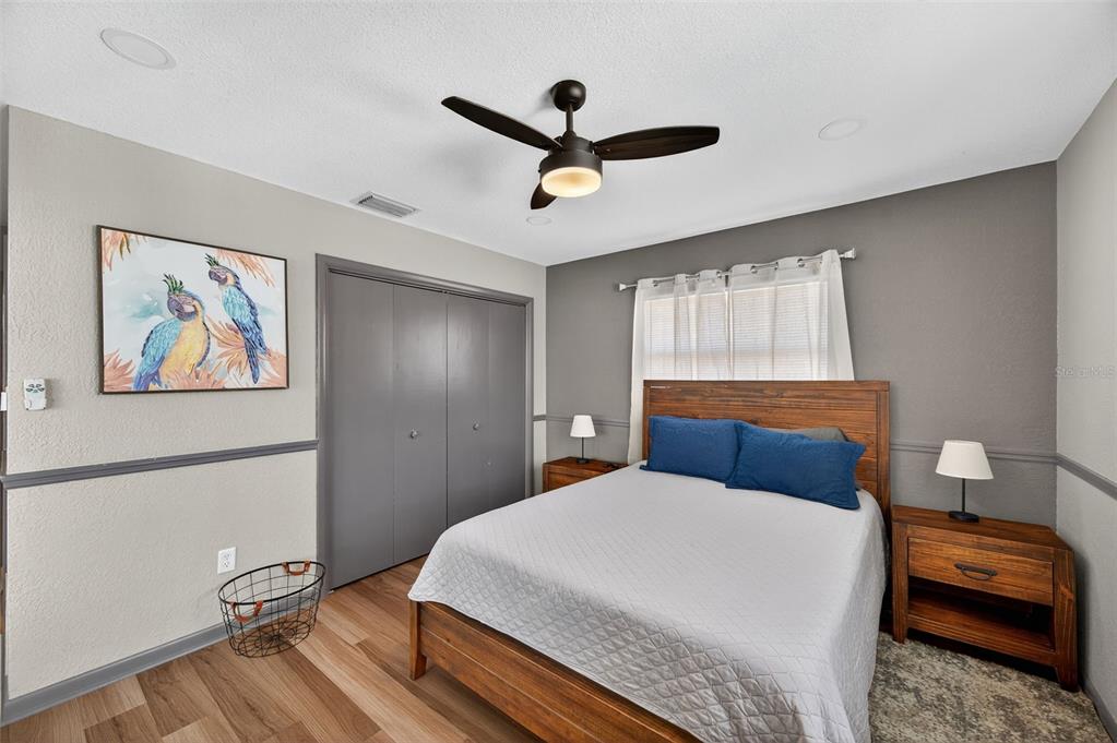 1576 Rosery Road Northeast Largo, FL 33756 - Photo 28 of 54 a bedroom with a bed and wooden floor