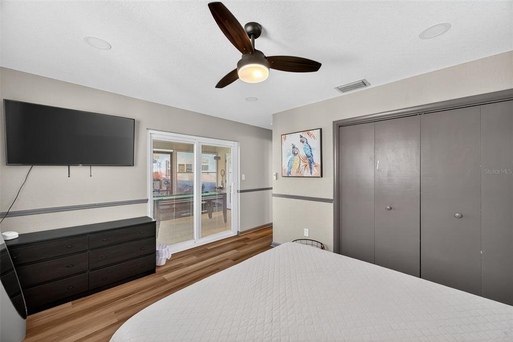 1576 Rosery Road Northeast Largo, FL 33756 - Photo 29 of 54 a bedroom with a bed and a flat screen tv