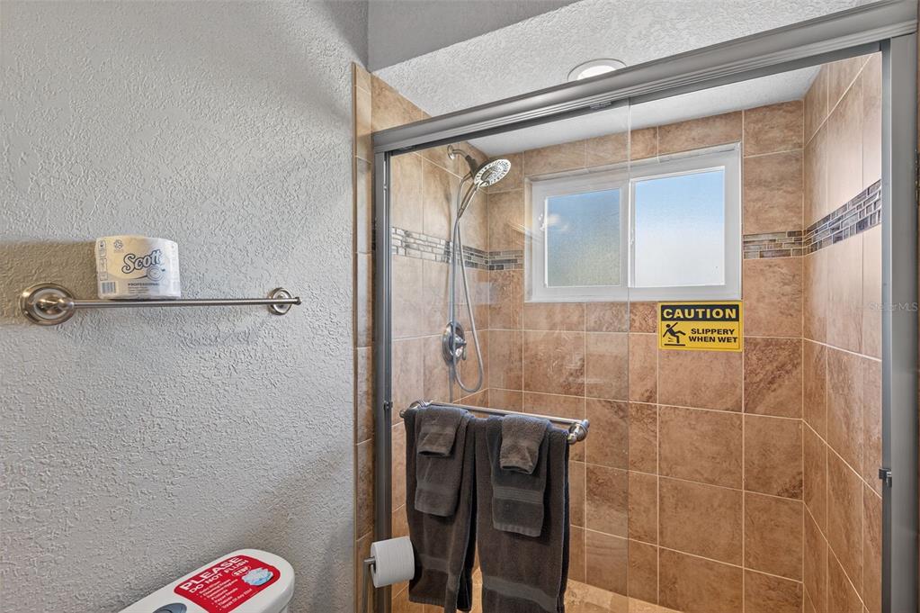 1576 Rosery Road Northeast Largo, FL 33756 - Photo 31 of 54 a bathroom with a shower and a sink