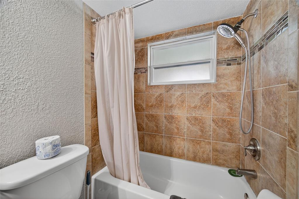 1576 Rosery Road Northeast Largo, FL 33756 - Photo 38 of 54 a bathroom with a bathtub and shower