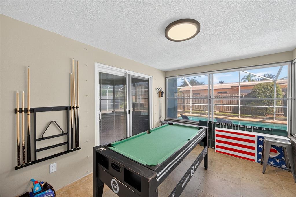 1576 Rosery Road Northeast Largo, FL 33756 - Photo 39 of 54 a room with pool table and windows
