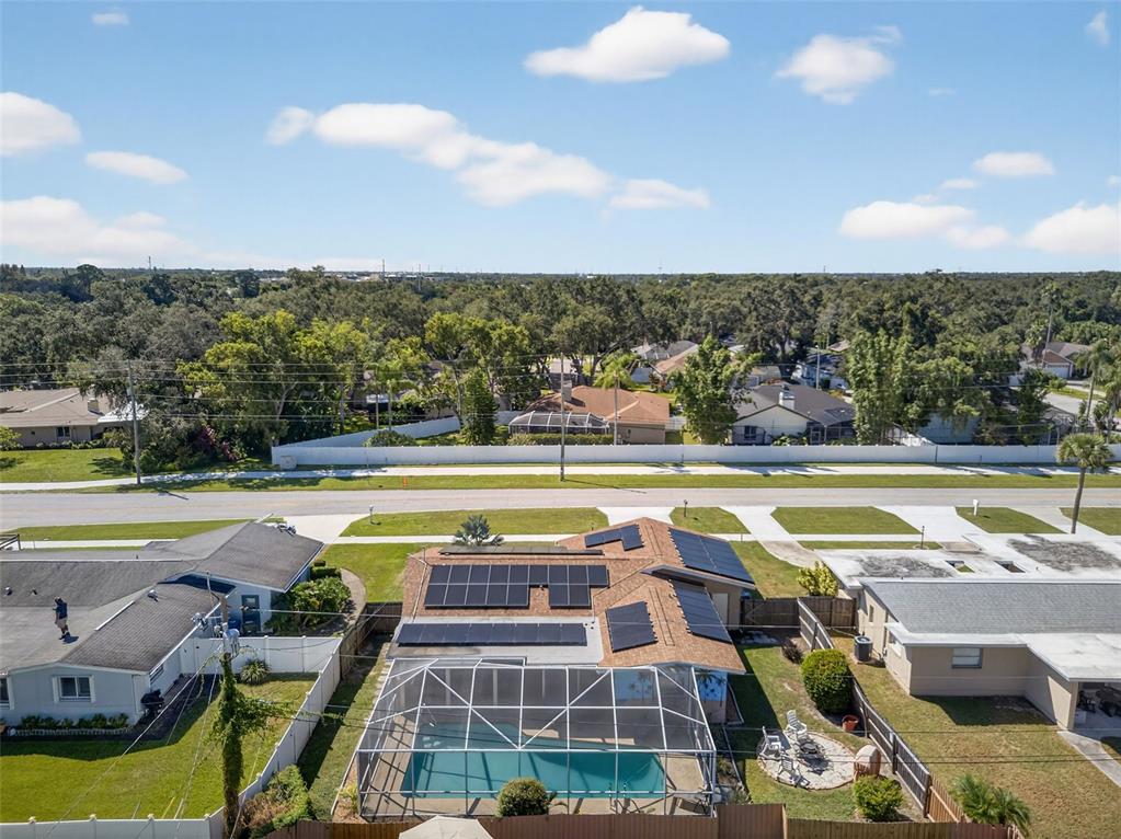 1576 Rosery Road Northeast Largo, FL 33756 - Photo 53 of 54 a view of a swimming pool with a patio and a yard
