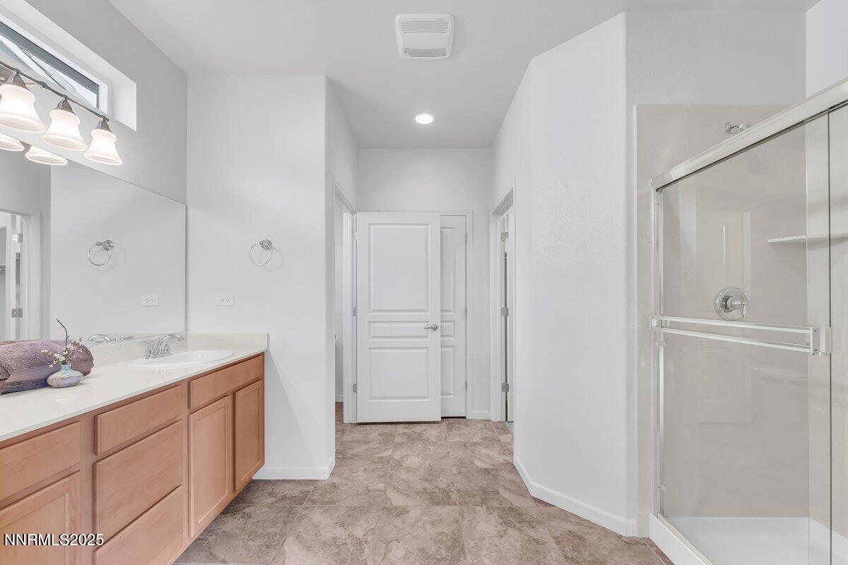 861 Larrimore Trail Reno, NV 89523 - Photo 11 of 24 a spacious bathroom with a granite countertop sink mirror and double