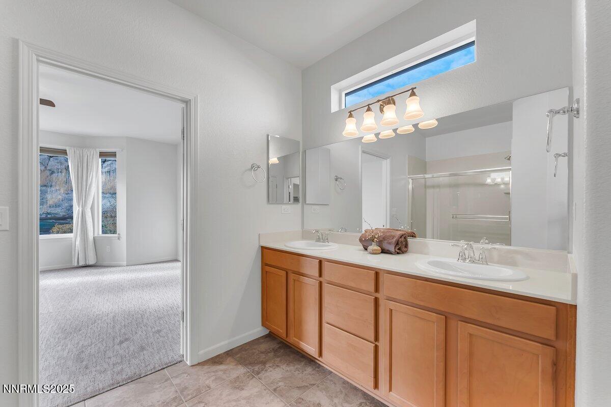 861 Larrimore Trail Reno, NV 89523 - Photo 12 of 24 a spacious bathroom with a granite countertop sink a mirror and a shower
