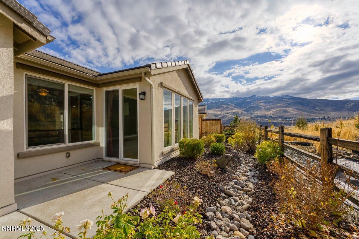 861 Larrimore Trail Reno, NV 89523 - Photo 17 of 24 a view of a house with a large window and potted plants