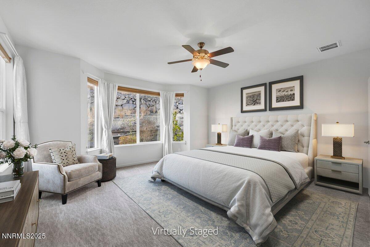 861 Larrimore Trail Reno, NV 89523 - Photo 10 of 24 a spacious bedroom with a bed couch and a window