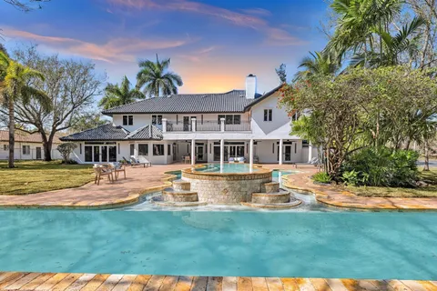 a front view of a house with swimming pool having outdoor seating