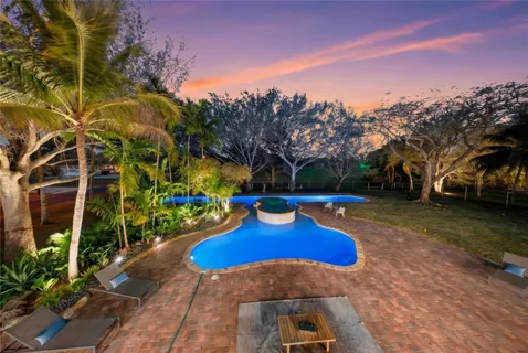 a living room with furniture fireplace and a large window