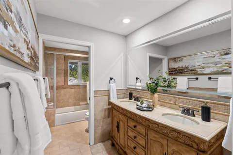 a spacious bedroom with a bed and a flat screen tv