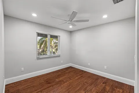 a dining room with wooden floor glass table and chairs