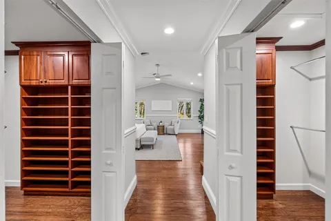 a view of a house with palm trees next to a yard