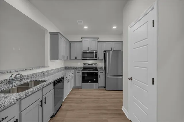 a kitchen with a refrigerator stove and sink