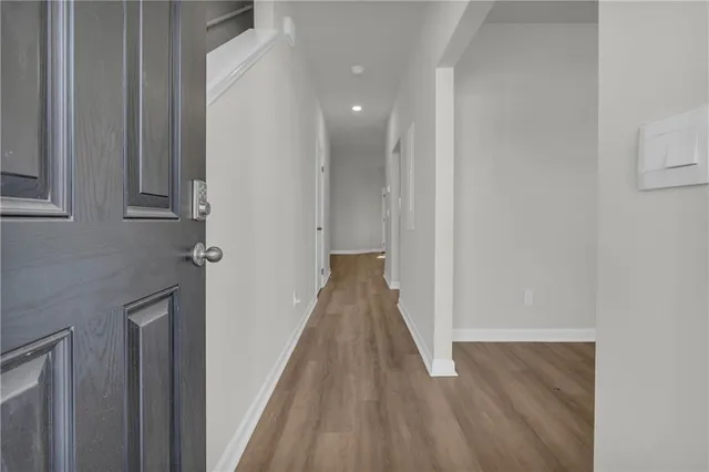 a view of a hallway with wooden floor