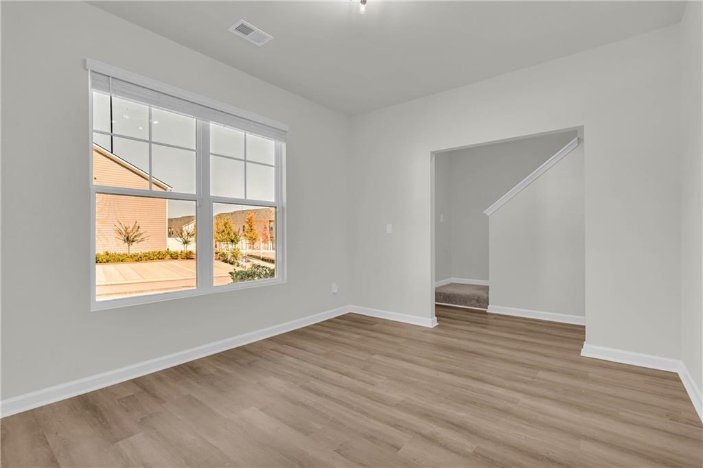 4289 Arcadia Drive Decatur, GA 30034 - Photo 10 of 11 an empty room with wooden floor and windows