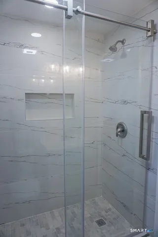 a white toilet sitting next to a bath tub