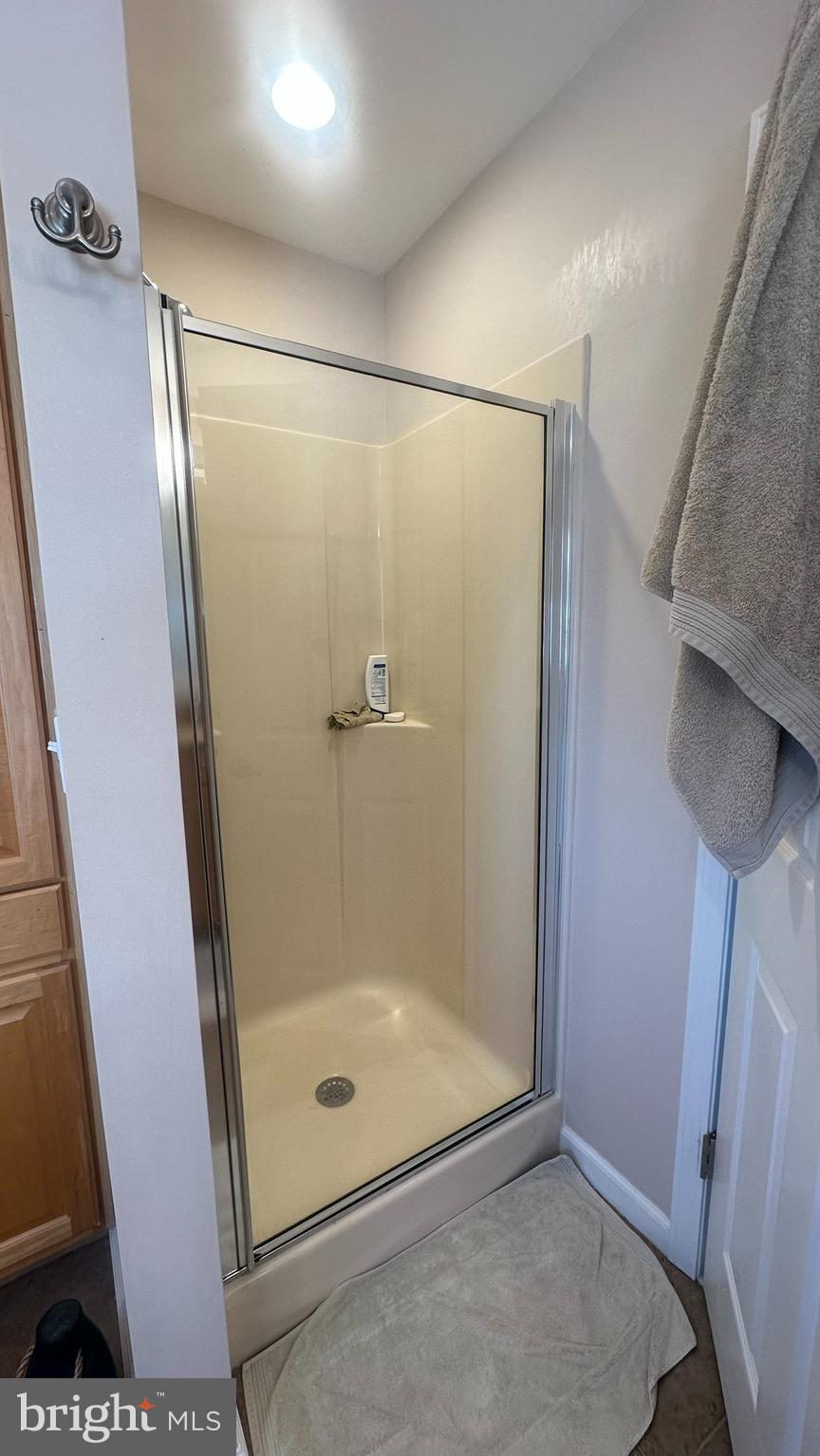 59 Weaver Drive Manahawkin, NJ 08050 - Photo 19 of 27 a bathroom with a glass shower door
