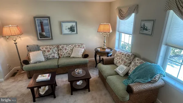 a view of a dining room with furniture and chandelier