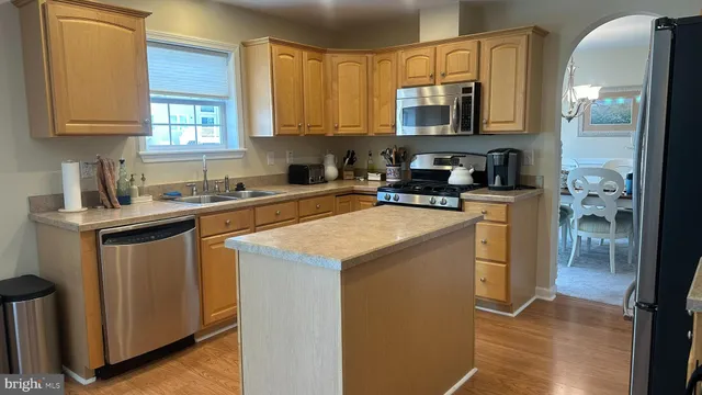 a kitchen with a refrigerator and cabinets