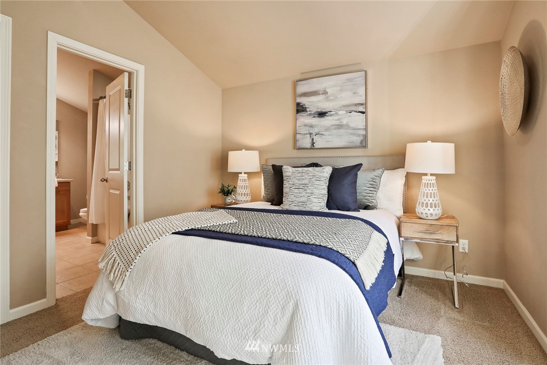 10126 Holman Road Northwest, Unit B Seattle, WA 98133 - Photo 22 of 28 a bedroom with a bed and a painting