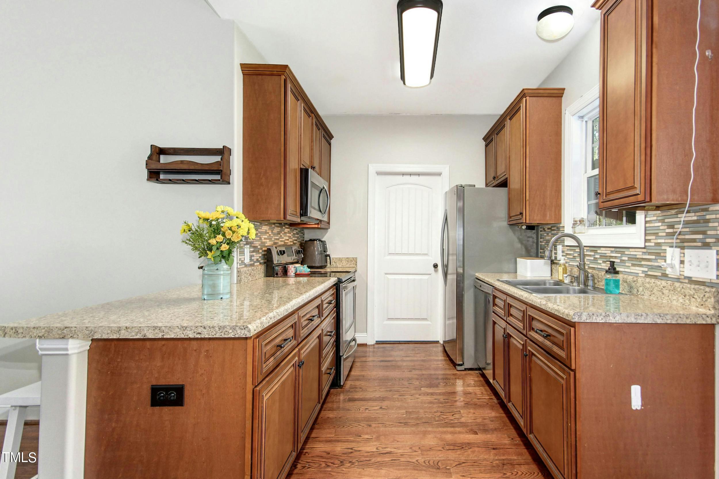 10354 Pasture Road Middlesex, NC 27557 - Photo 7 of 26 a kitchen with stainless steel appliances granite countertop a refrigerator a sink and dishwasher