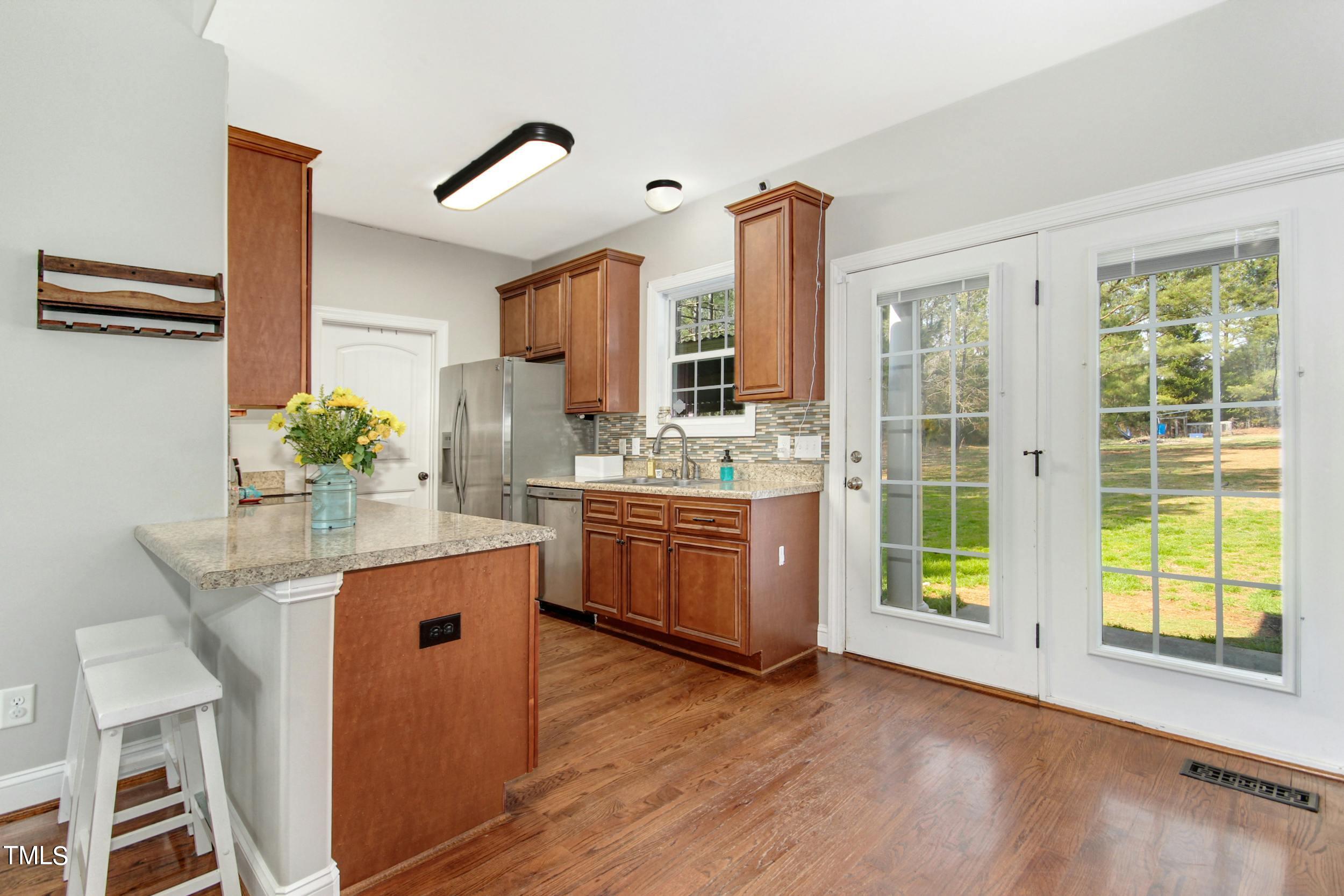 10354 Pasture Road Middlesex, NC 27557 - Photo 8 of 26 a kitchen with stainless steel appliances granite countertop a sink stove and cabinets