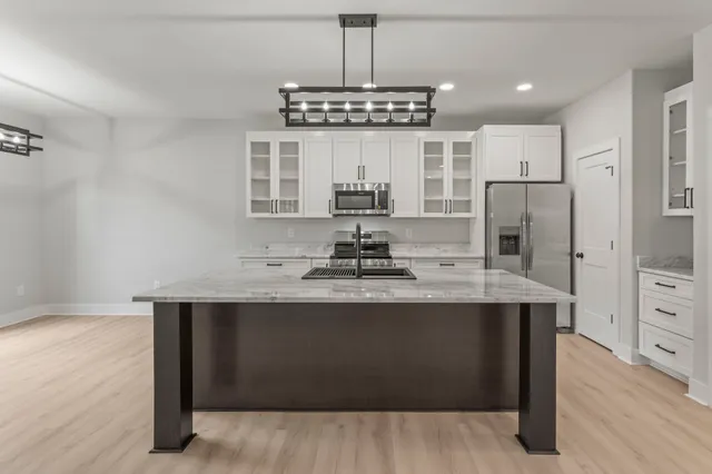 a kitchen with stainless steel appliances a sink and a refrigerator
