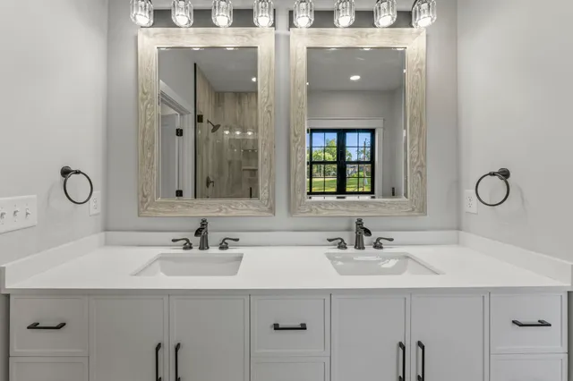 a bathroom with a sink double vanity and mirror