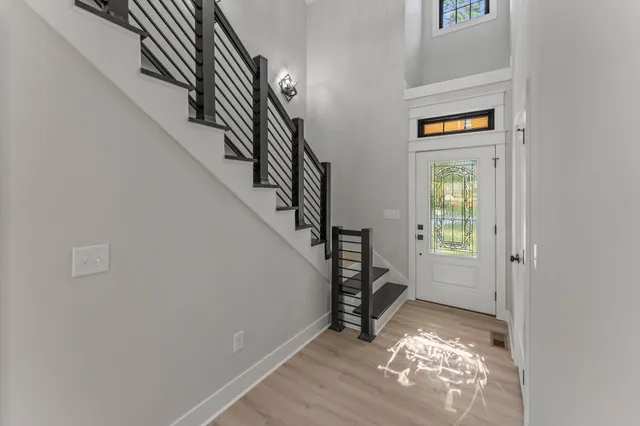 a view of entryway and hall with wooden floor