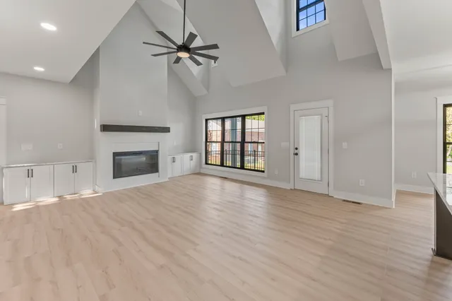 a view of empty room with wooden floor and fireplace