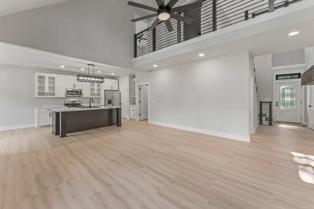 a view of a kitchen with a sink and a refrigerator