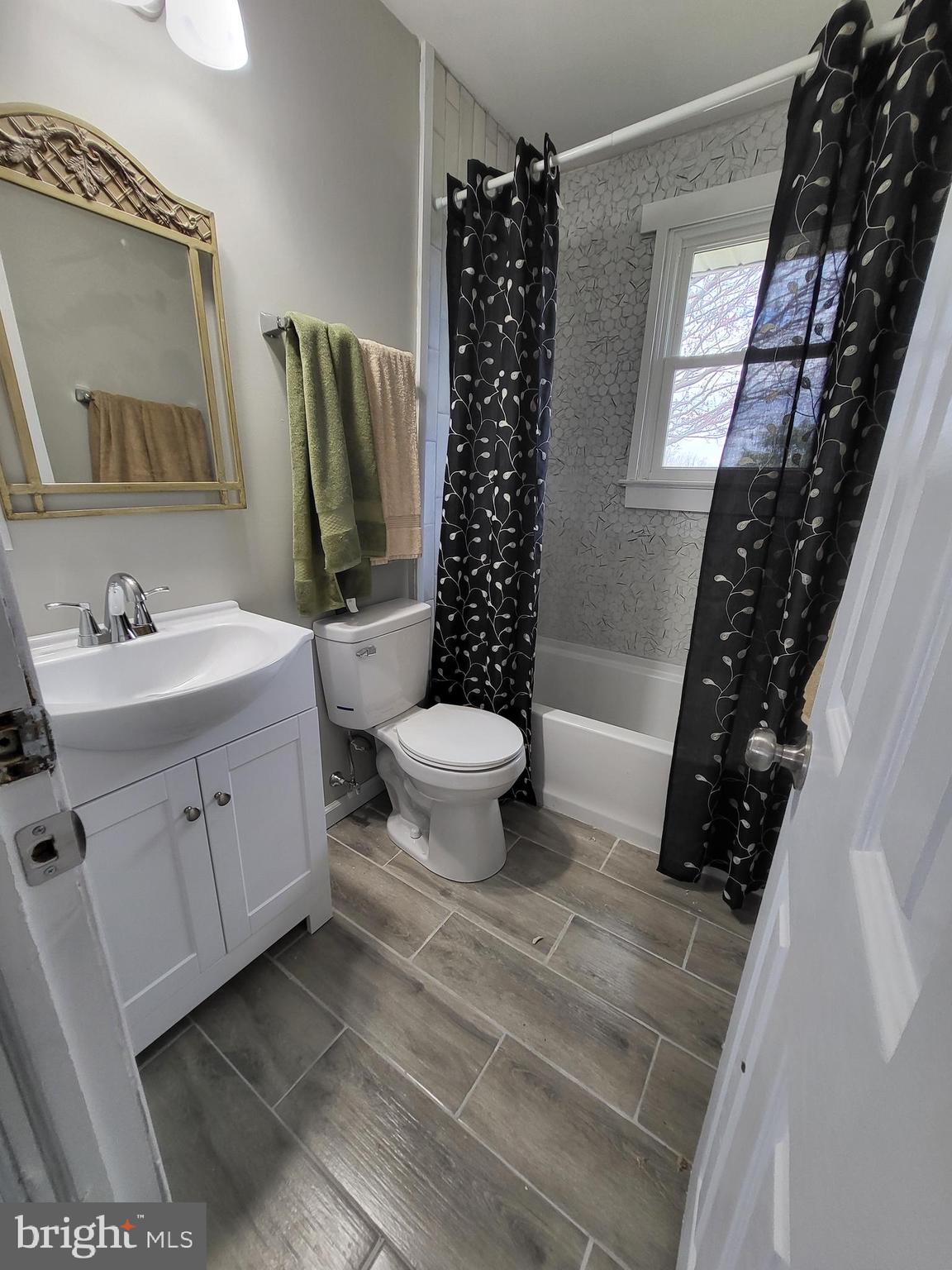 955 Kitts Hummock Road Dover, DE 19901 - Photo 13 of 16 a bathroom with a double vanity sink toilet and shower
