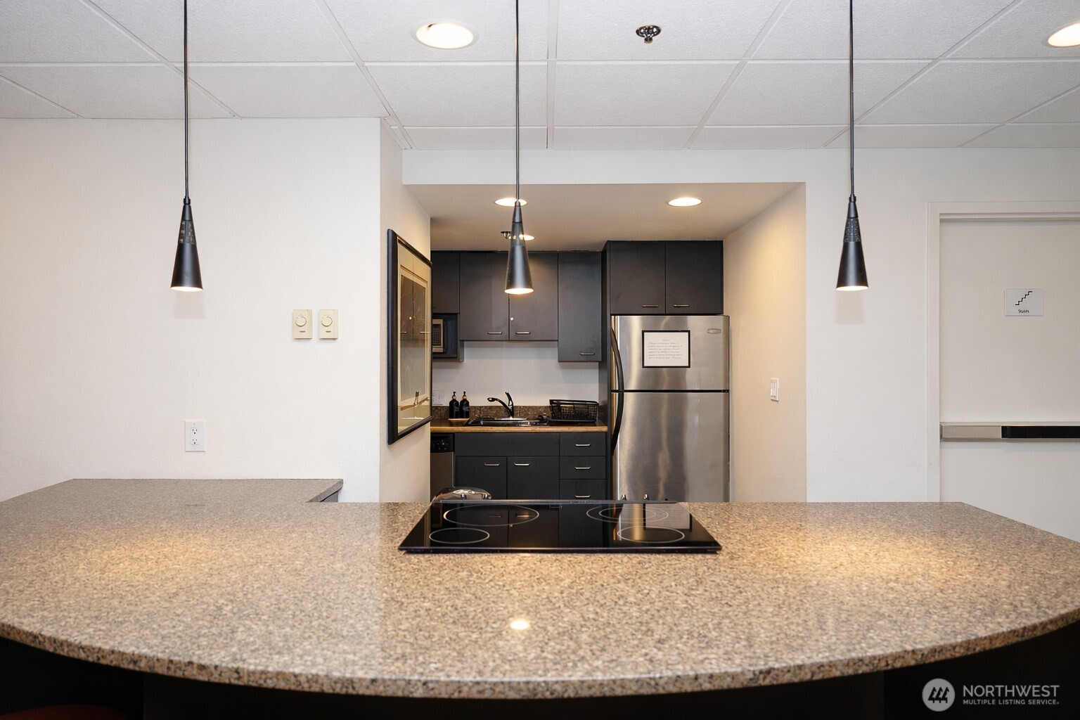 121 Vine Street, Unit 1702 Seattle, WA 98121 - Photo 26 of 37 a kitchen with kitchen island sink stove and refrigerator