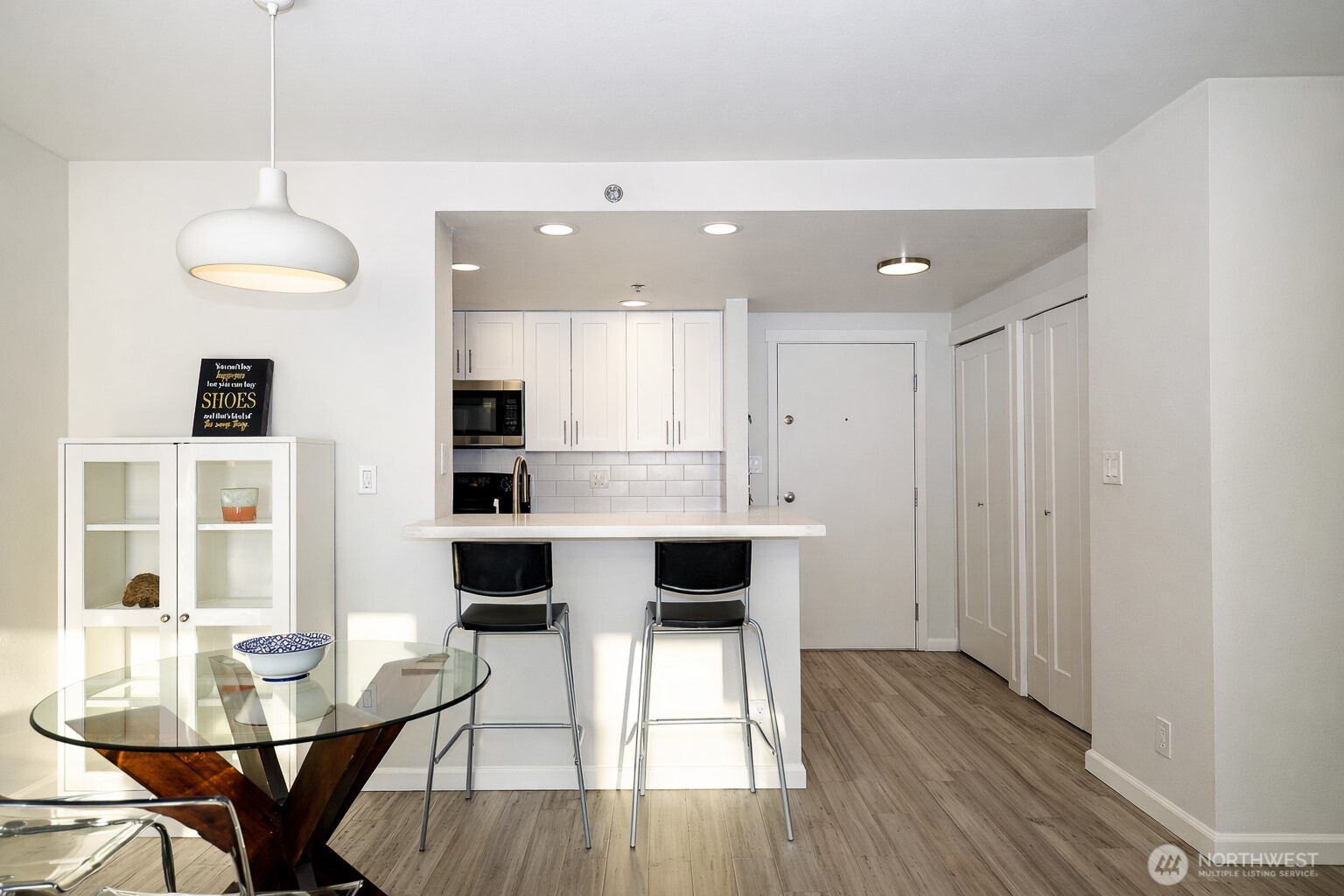 121 Vine Street, Unit 1702 Seattle, WA 98121 - Photo 6 of 37 a view of a dining room with furniture and wooden floor