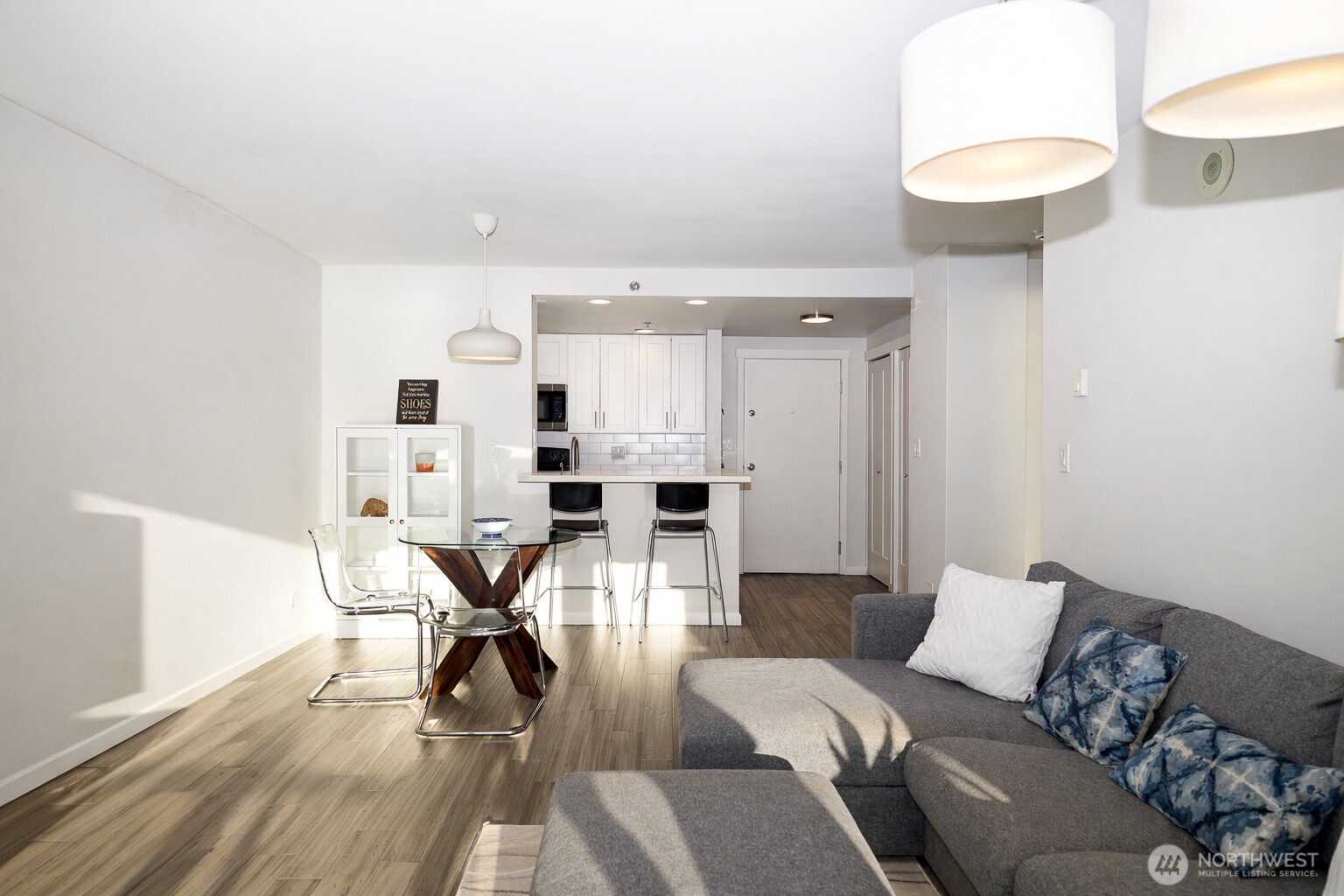 121 Vine Street, Unit 1702 Seattle, WA 98121 - Photo 7 of 37 a living room with furniture a dining table and a fireplace