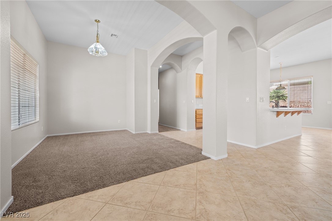 9282 West Viking Road Las Vegas, NV 89147 - Photo 8 of 38 Tiled empty room with carpet floors, baseboards, a
