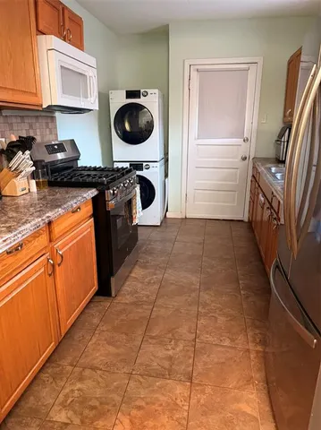 a kitchen with a sink a stove top oven and cabinets