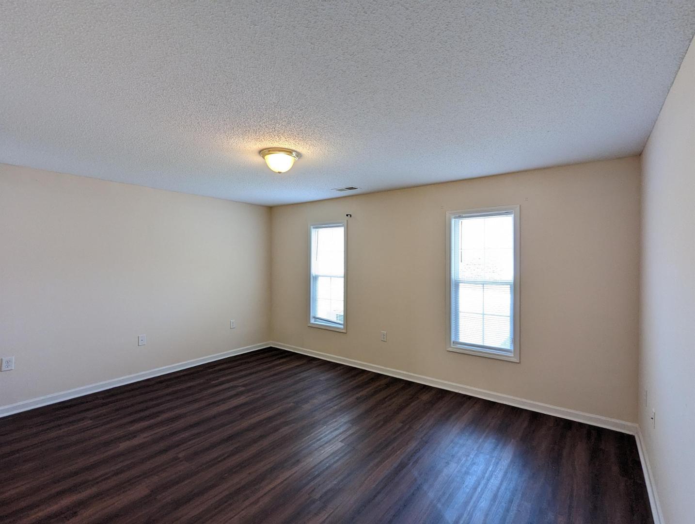 11370 Clubhaven Place Raleigh, NC 27617 - Photo 12 of 19 an empty room with wooden floor and windows