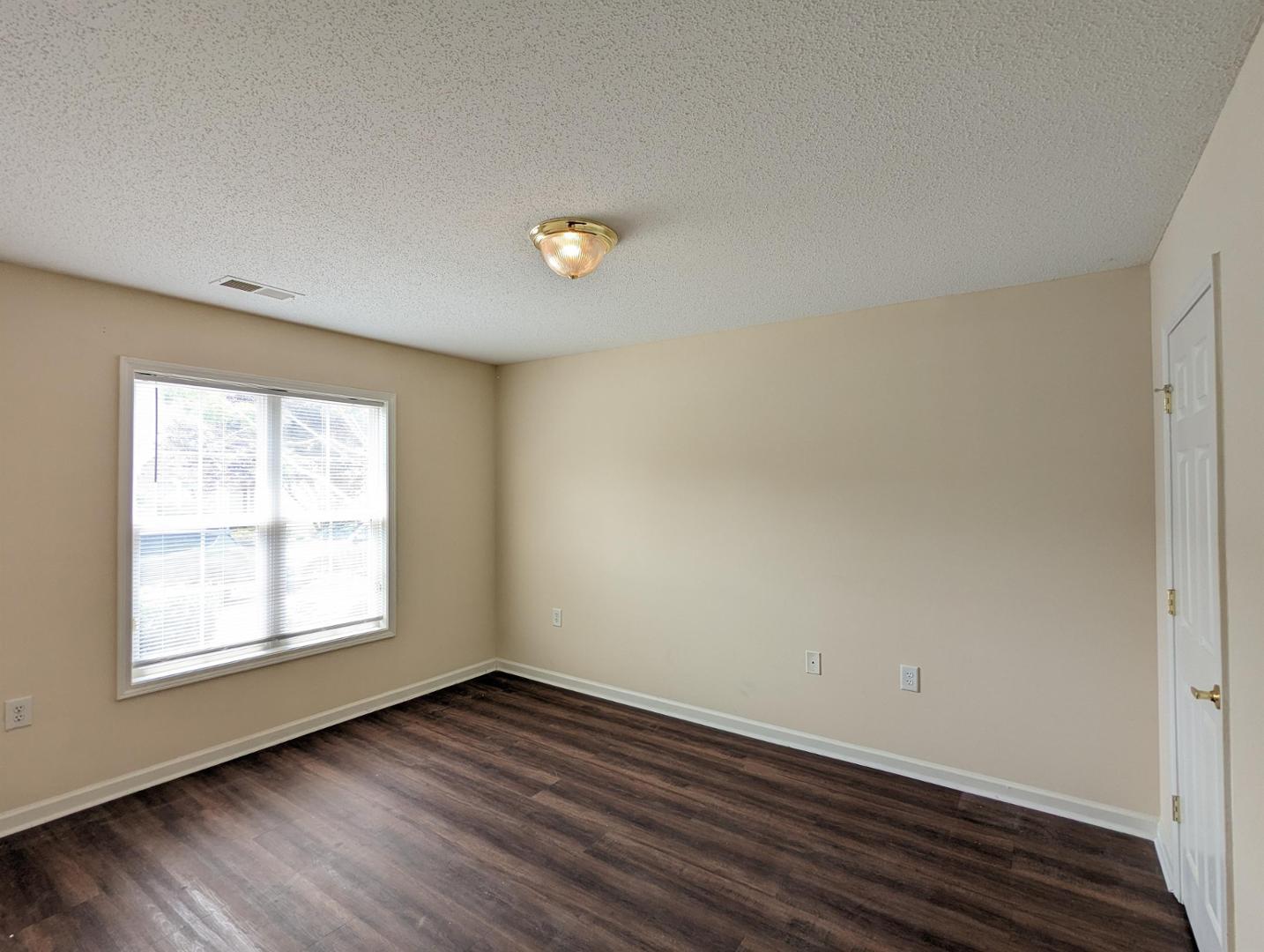 11370 Clubhaven Place Raleigh, NC 27617 - Photo 13 of 19 an empty room with wooden floor and windows