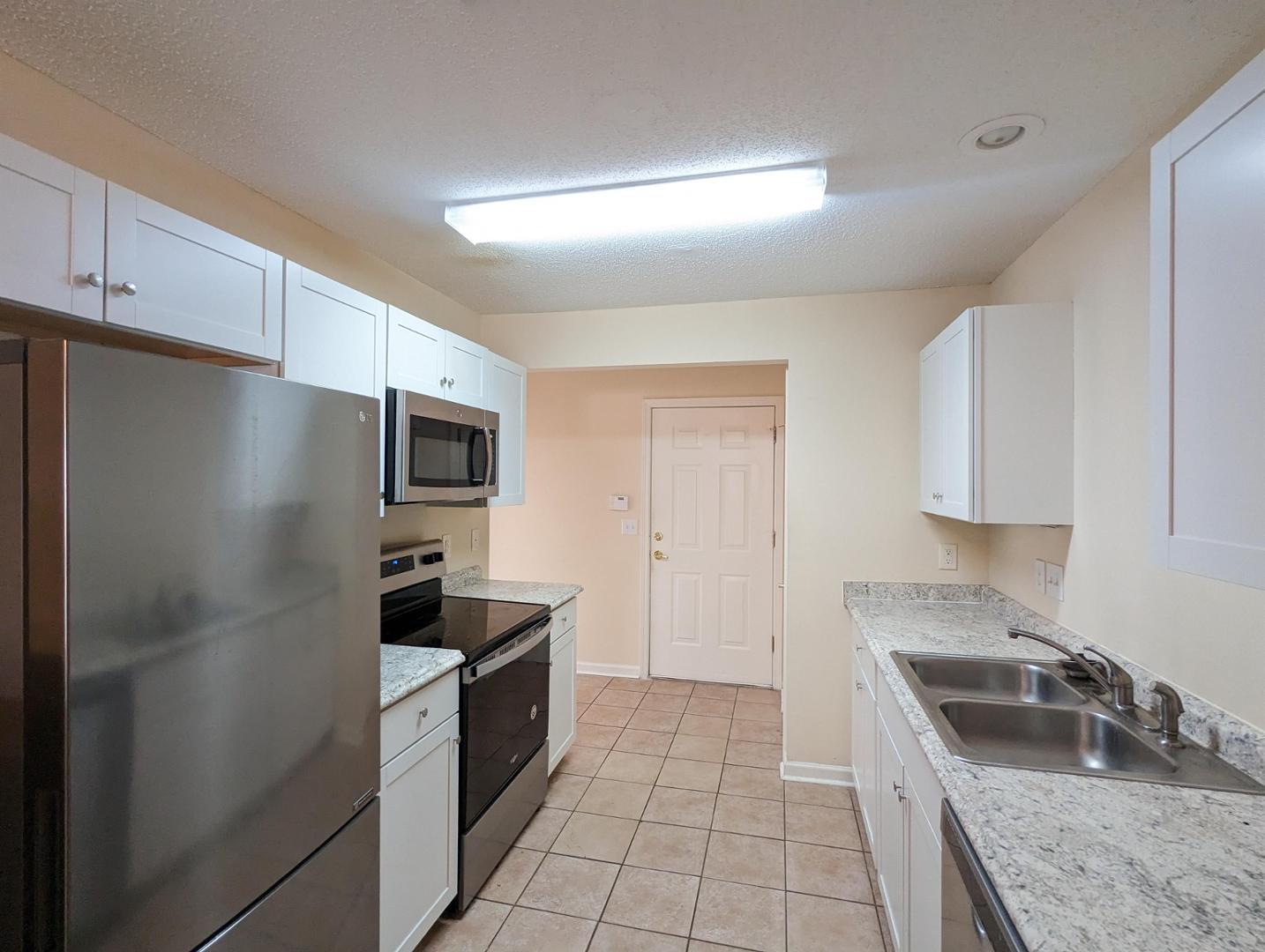 11370 Clubhaven Place Raleigh, NC 27617 - Photo 5 of 19 a kitchen with granite countertop a refrigerator and a sink