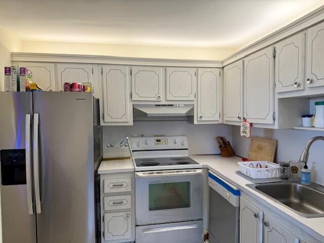 151 Tuscany Lane, Unit 151 Delray Beach, FL 33446 - Photo 4 of 4 a kitchen with stainless steel appliances granite countertop a refrigerator sink and cabinets
