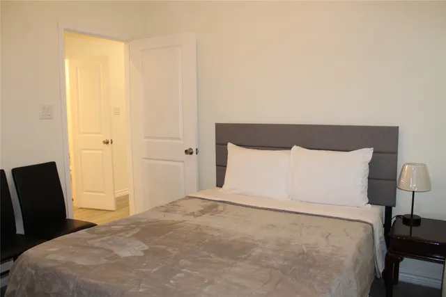 a large white bed in a white room