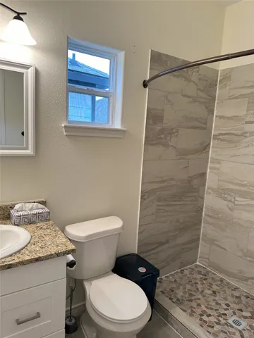 a bathroom with a toilet and a shower