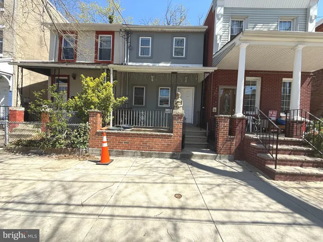 a view of a brick house with potted plants