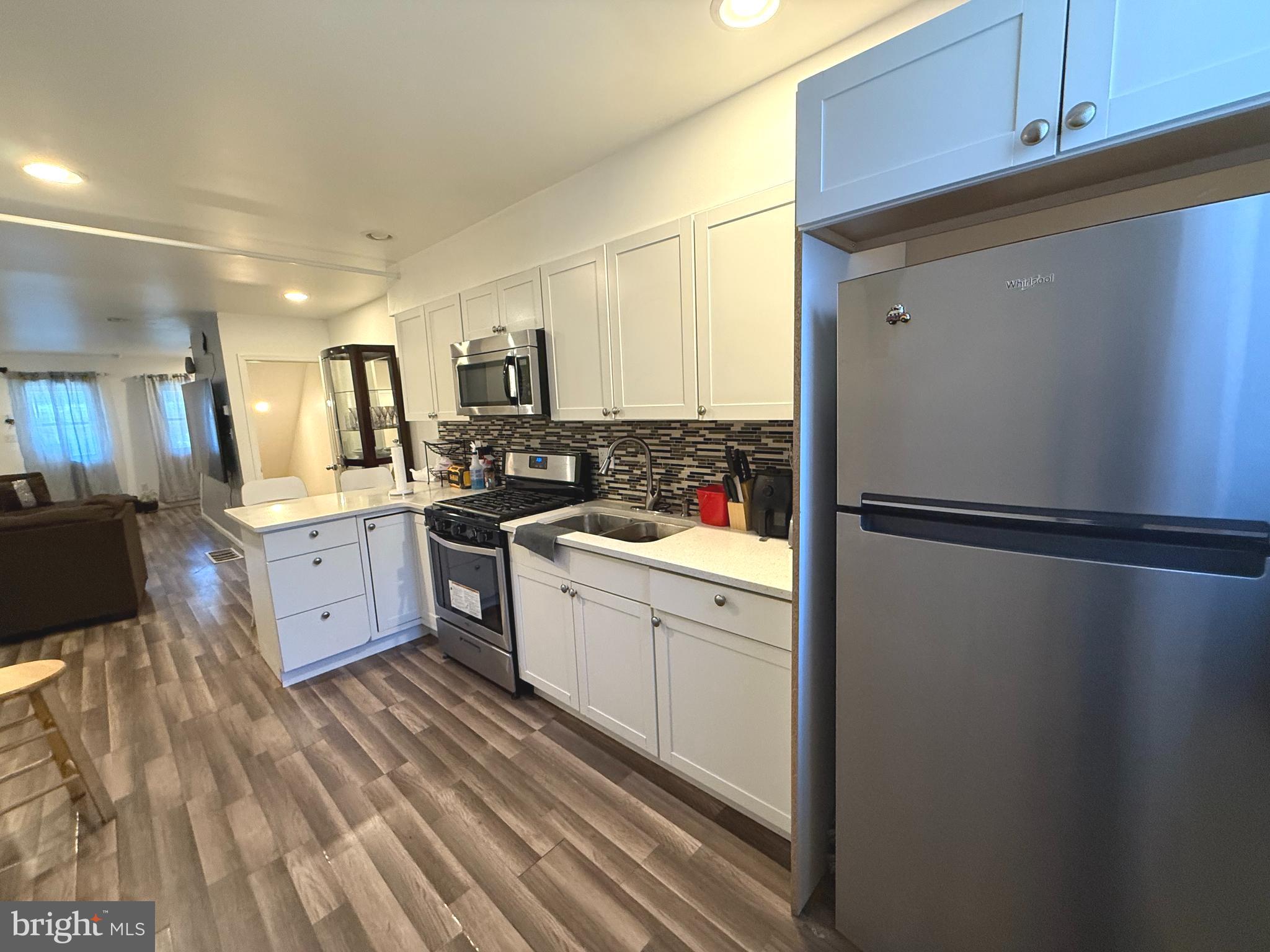 653 North 37th Street Philadelphia, PA 19104 - Photo 6 of 20 a kitchen with stainless steel appliances a refrigerator sink and cabinets