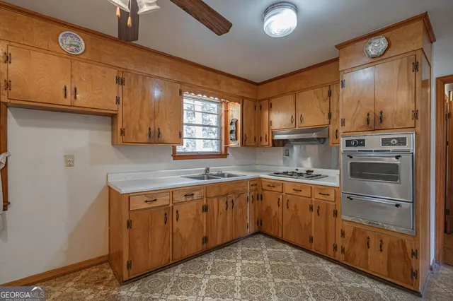 a kitchen with a sink window and cabinets