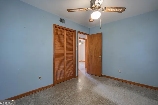a view of room with window and ceiling fan