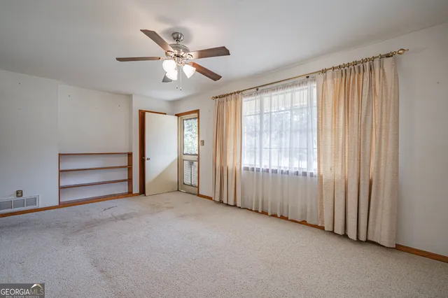 a view of an empty room with a window