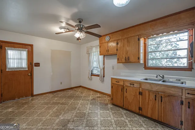 a kitchen with a sink cabinets and window